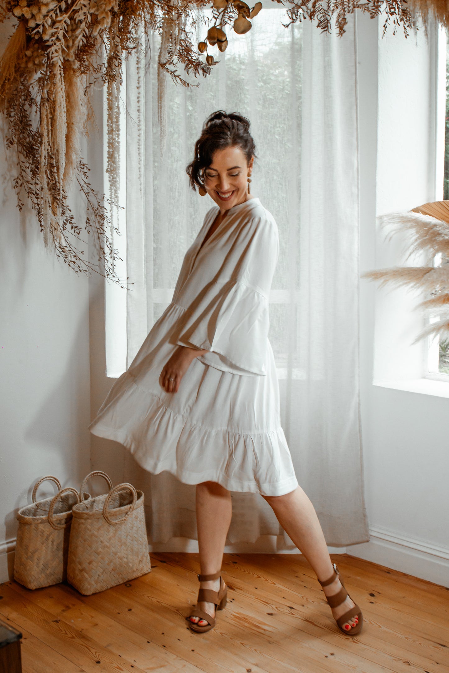 Made from a soft, breathable Rayon/Linen blend fabric, the Anneen Henze Annabelle Dress will be your go-to item this season. Featuring a mandarin collar with buttons (can button down), two-tiered-frill-bottom and soft flowy sleeves. The style can be worn loose and relaxed or taken in at the waist with a belt. Incredibly soft and flattering design.