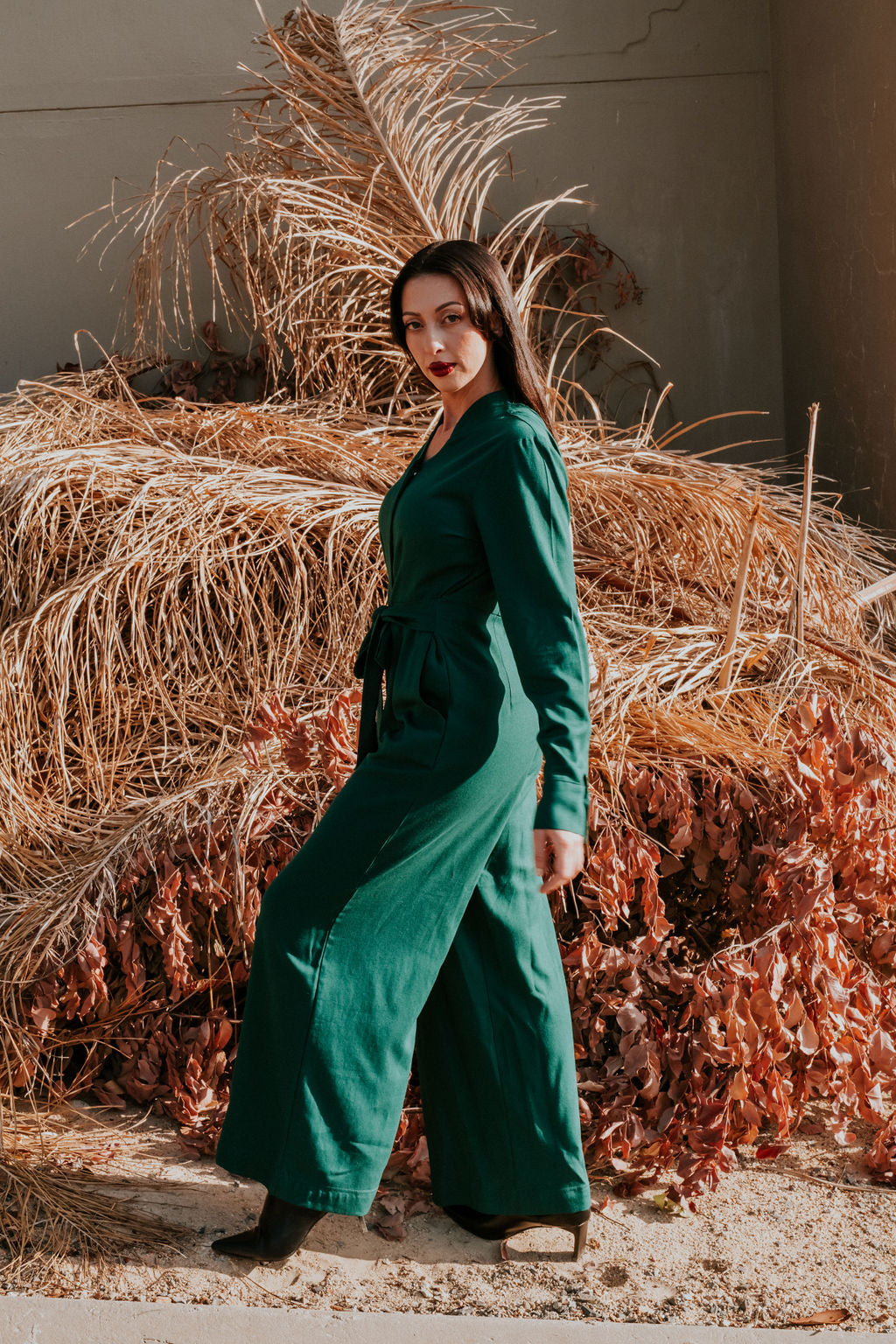 Made from a soft, breathable Rayon/Linen blend fabric, the Anneen Henze Jumpsuit will be your go-to item this season. Featuring a mandarin collar with button placket with press studs, long sleeves with cuff detail and a wide-legged bottom with pockets. The jumpsuit also have a self fabric tie that can be tied to the front and back. Darts were added to the back and front of the top and bottom to create the most romantic silhouette. This is truly an investment piece.