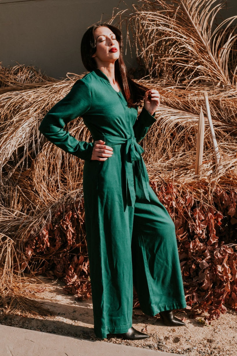 Made from a soft, breathable Rayon/Linen blend fabric, the Anneen Henze Jumpsuit will be your go-to item this season. Featuring a mandarin collar with button placket with press studs, long sleeves with cuff detail and a wide-legged bottom with pockets. The jumpsuit also have a self fabric tie that can be tied to the front and back. Darts were added to the back and front of the top and bottom to create the most romantic silhouette. This is truly an investment piece.